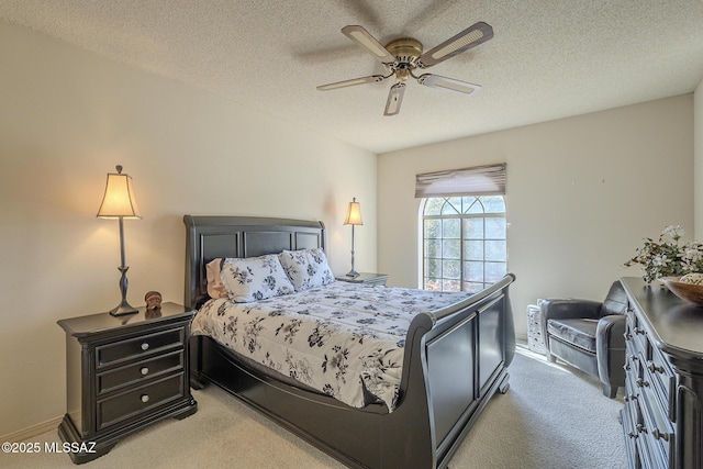 bedroom with carpet, ceiling fan, and a textured ceiling