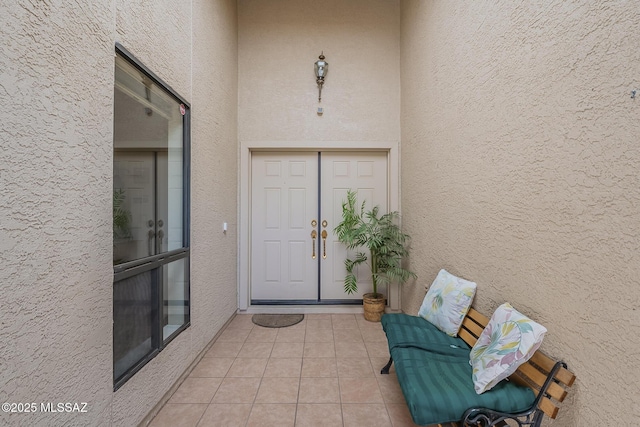 property entrance with stucco siding