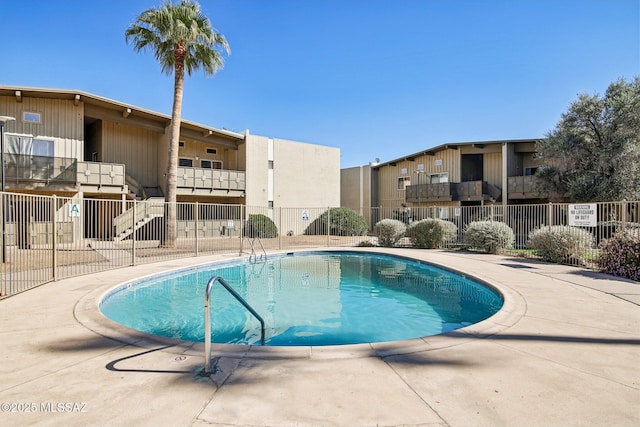 community pool featuring fence