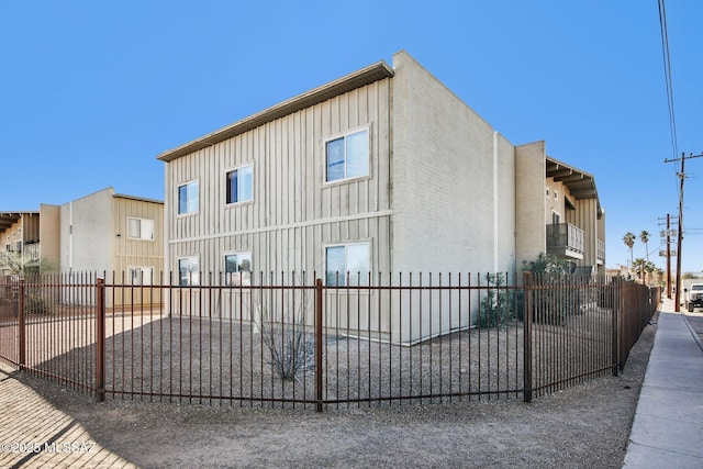 view of home's exterior featuring board and batten siding and fence