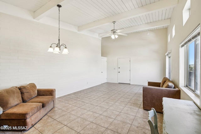 living room featuring light tile patterned floors, brick wall, beamed ceiling, and a towering ceiling