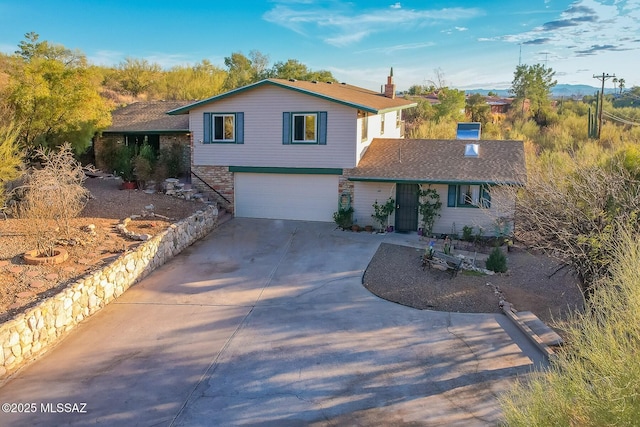 view of front facade with a garage and concrete driveway