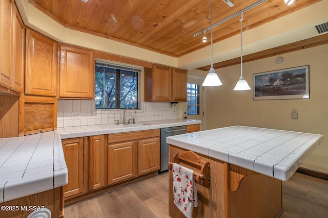 kitchen featuring wood finished floors, a sink, dishwasher, wooden ceiling, and tasteful backsplash