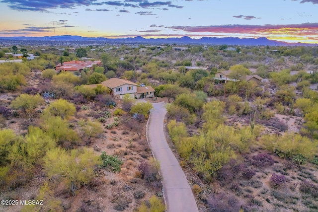 aerial view at dusk featuring a mountain view