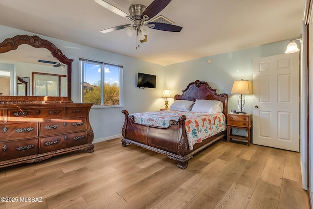 bedroom featuring baseboards, ceiling fan, and wood finished floors