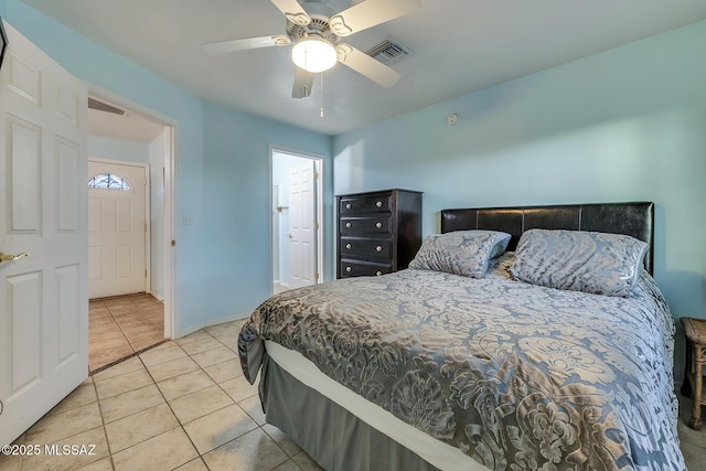 tiled bedroom with visible vents, ceiling fan, connected bathroom, and baseboards