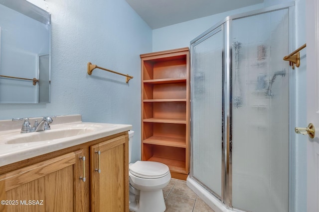 full bathroom with tile patterned floors, a shower stall, toilet, and vanity