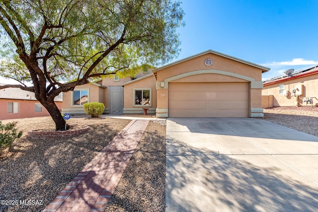 view of front of property featuring an attached garage, concrete driveway, and stucco siding