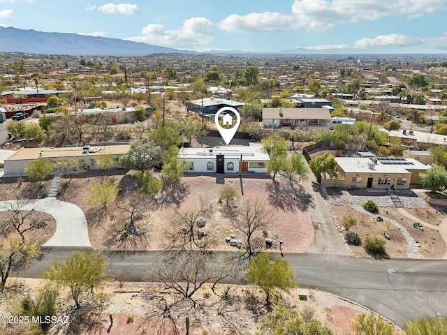 birds eye view of property with a mountain view