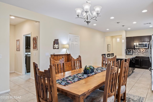 tiled dining area featuring a chandelier