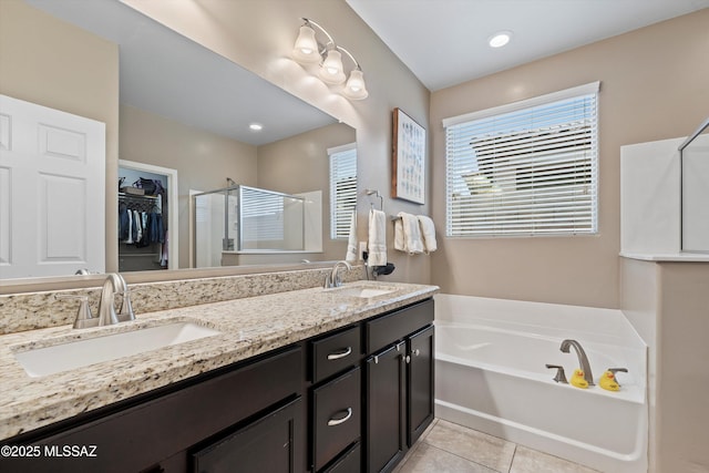 bathroom featuring tile patterned floors, separate shower and tub, and vanity