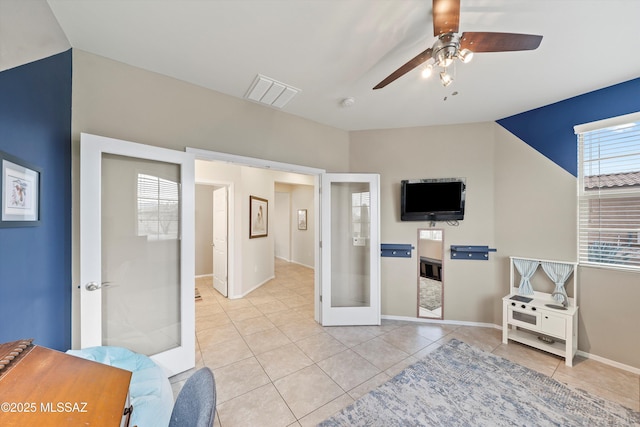 interior space with french doors and ceiling fan