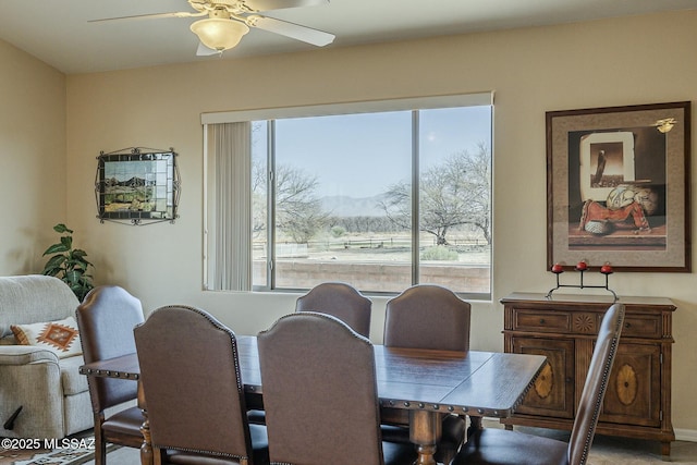 dining room featuring a mountain view, plenty of natural light, and a ceiling fan