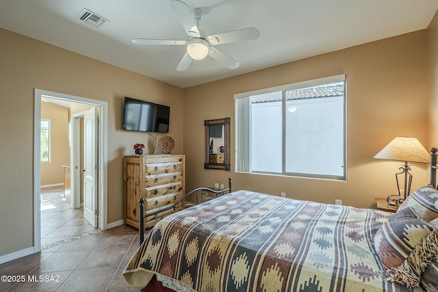 bedroom with multiple windows, visible vents, baseboards, and tile patterned floors