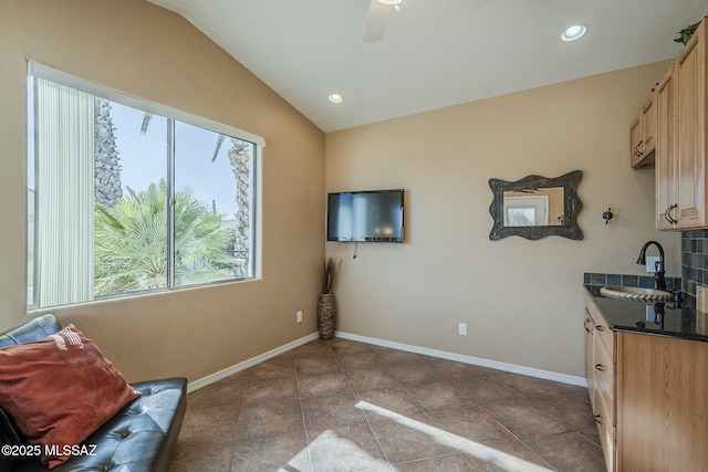 living area featuring lofted ceiling, recessed lighting, a ceiling fan, baseboards, and tile patterned floors