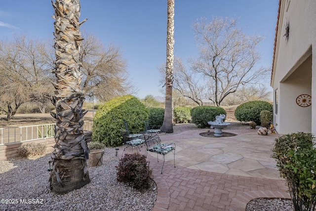 view of patio / terrace featuring fence