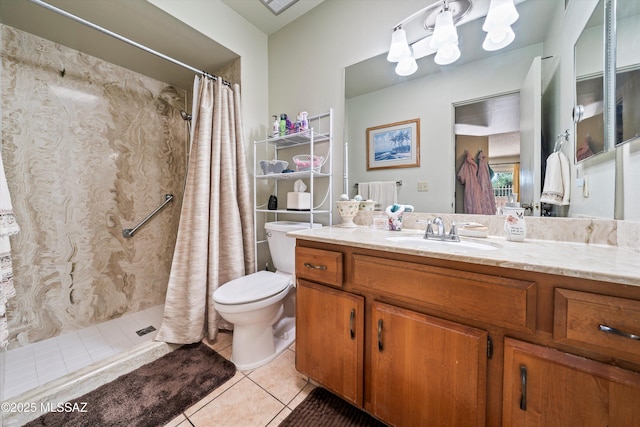 bathroom with toilet, tile patterned flooring, vanity, and curtained shower