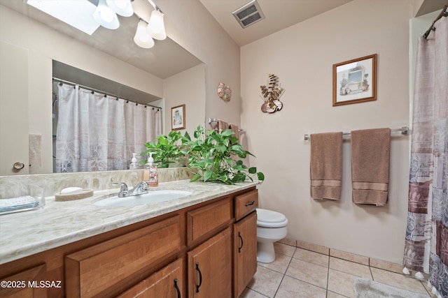 bathroom featuring vanity, toilet, and tile patterned floors