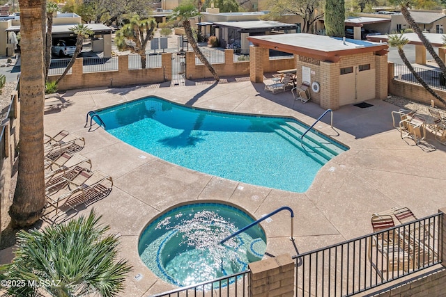 view of swimming pool with a hot tub, a patio, and a bar