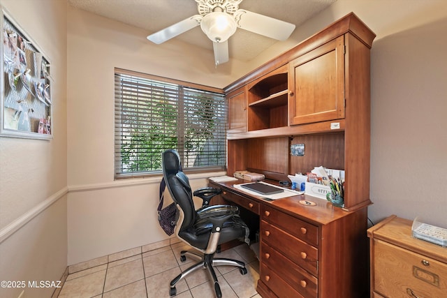 tiled home office featuring ceiling fan