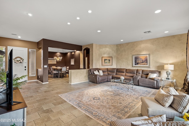 living area featuring baseboards, visible vents, and recessed lighting