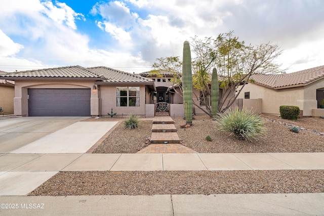 view of front of property with a garage, fence, driveway, a gate, and stucco siding