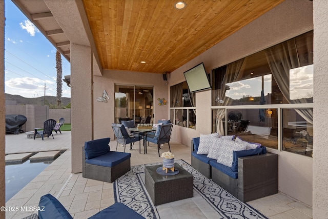 view of patio featuring fence and an outdoor living space