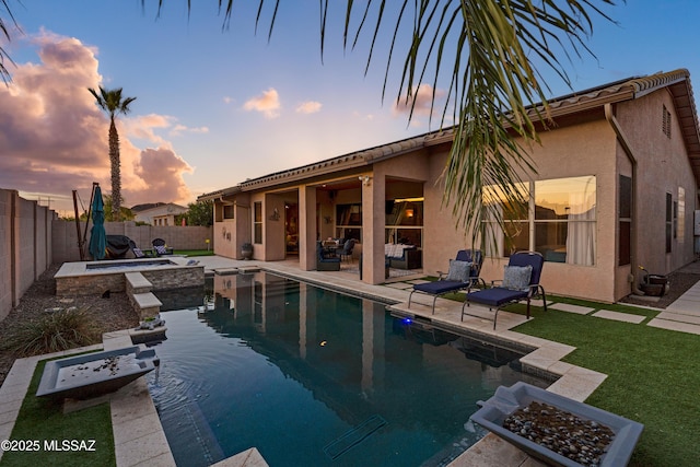 view of swimming pool featuring a fenced in pool, a fenced backyard, a patio, and an in ground hot tub