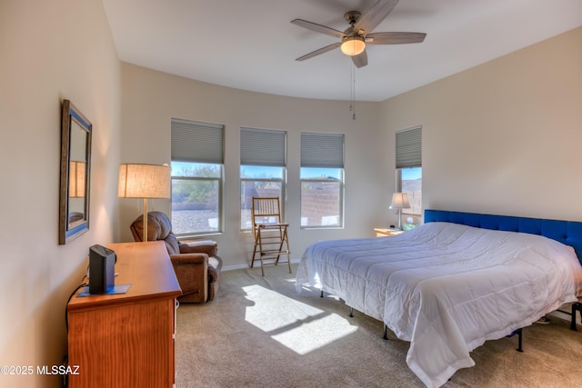 bedroom with carpet, ceiling fan, and baseboards