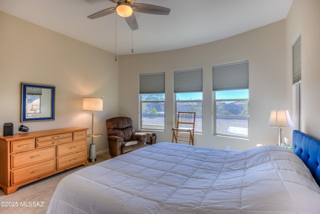 bedroom with a ceiling fan and light colored carpet