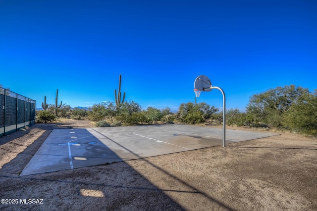 view of basketball court featuring community basketball court and fence