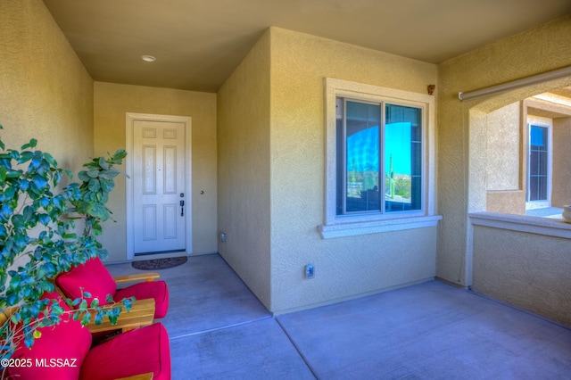 doorway to property featuring stucco siding