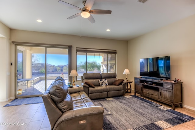 living room featuring light wood-style floors, ceiling fan, baseboards, and recessed lighting