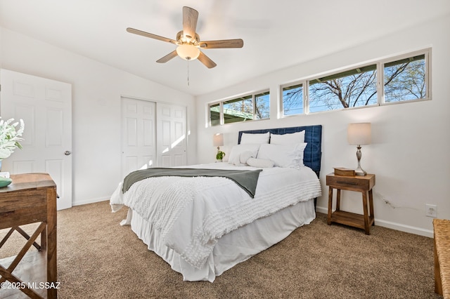 carpeted bedroom featuring a ceiling fan, a closet, vaulted ceiling, and baseboards