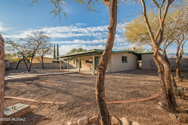 exterior space with fence and stucco siding