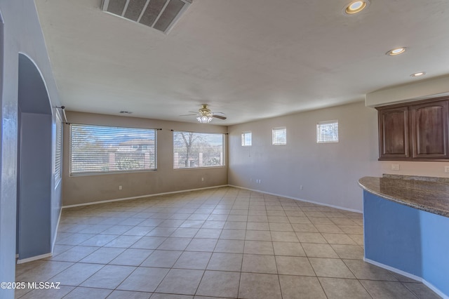 interior space featuring light tile patterned flooring, recessed lighting, visible vents, baseboards, and a ceiling fan