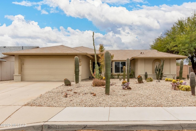 ranch-style home with concrete driveway, brick siding, an attached garage, and stucco siding