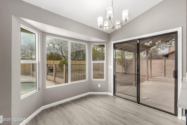 interior space with an inviting chandelier and vaulted ceiling