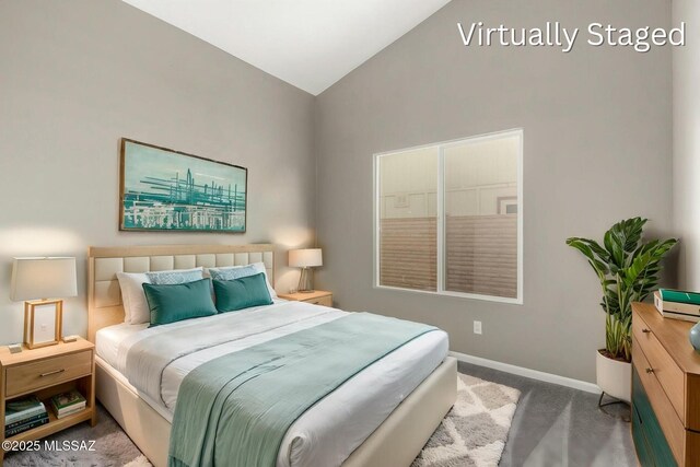 carpeted bedroom featuring baseboards and lofted ceiling