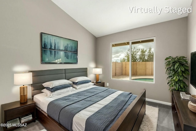 carpeted bedroom with lofted ceiling and baseboards