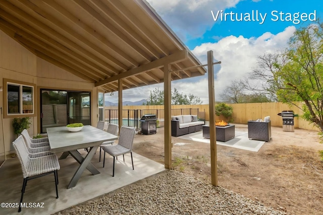 view of patio with an outdoor living space with a fire pit, outdoor dining space, a fenced backyard, and grilling area