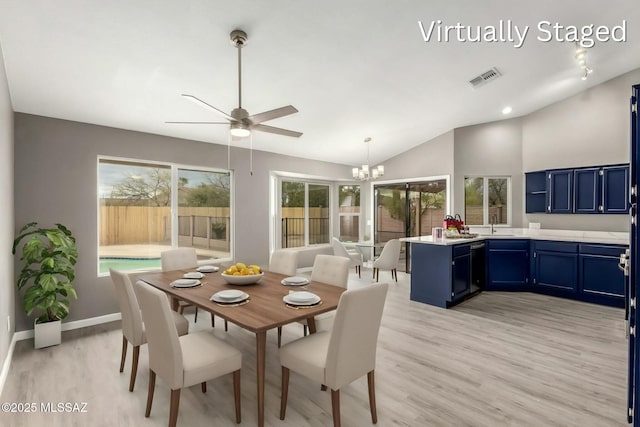 dining area with visible vents, light wood-type flooring, baseboards, and vaulted ceiling