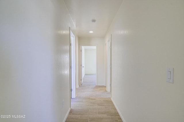 hallway with light hardwood / wood-style flooring