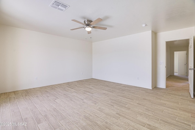 spare room featuring ceiling fan and light wood-type flooring