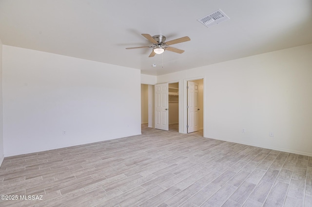 unfurnished room with light wood-type flooring and ceiling fan