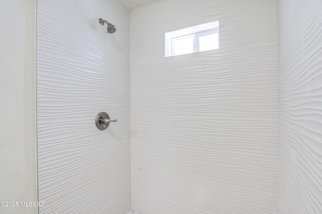 interior details with a tile shower