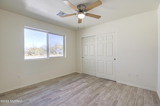 unfurnished bedroom with ceiling fan, a closet, and light hardwood / wood-style floors