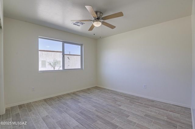 spare room featuring ceiling fan and light hardwood / wood-style flooring