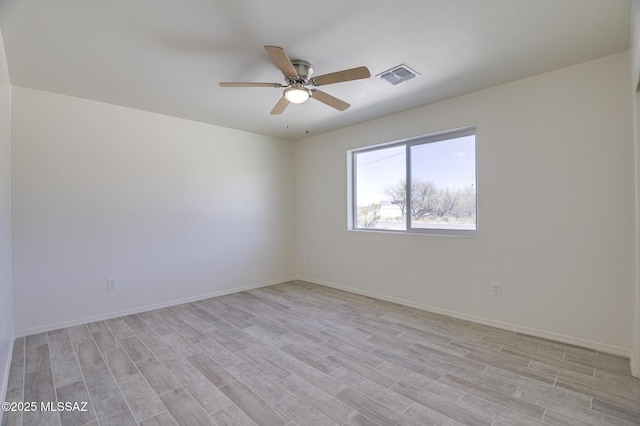 empty room featuring ceiling fan and light hardwood / wood-style flooring