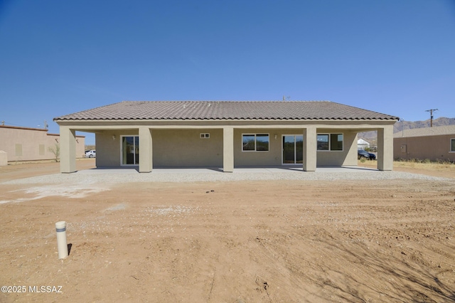 back of property featuring a patio area